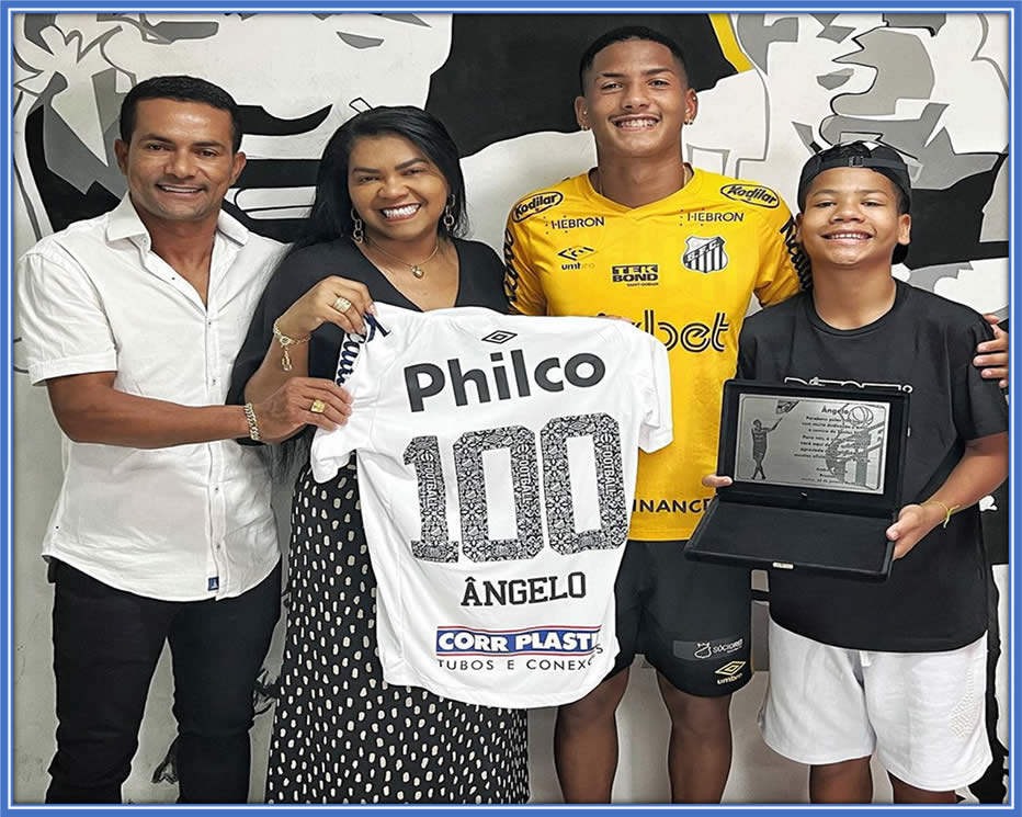 In this photo, Angelo, the family's pillar of support, celebrates his 100th game milestone with Santos — a cherished moment for his family. He is proud to have donned the Santos jersey, a club that once had legends like Pele and Neymar, is palpable. Credit: Instagram/angelogabriel.