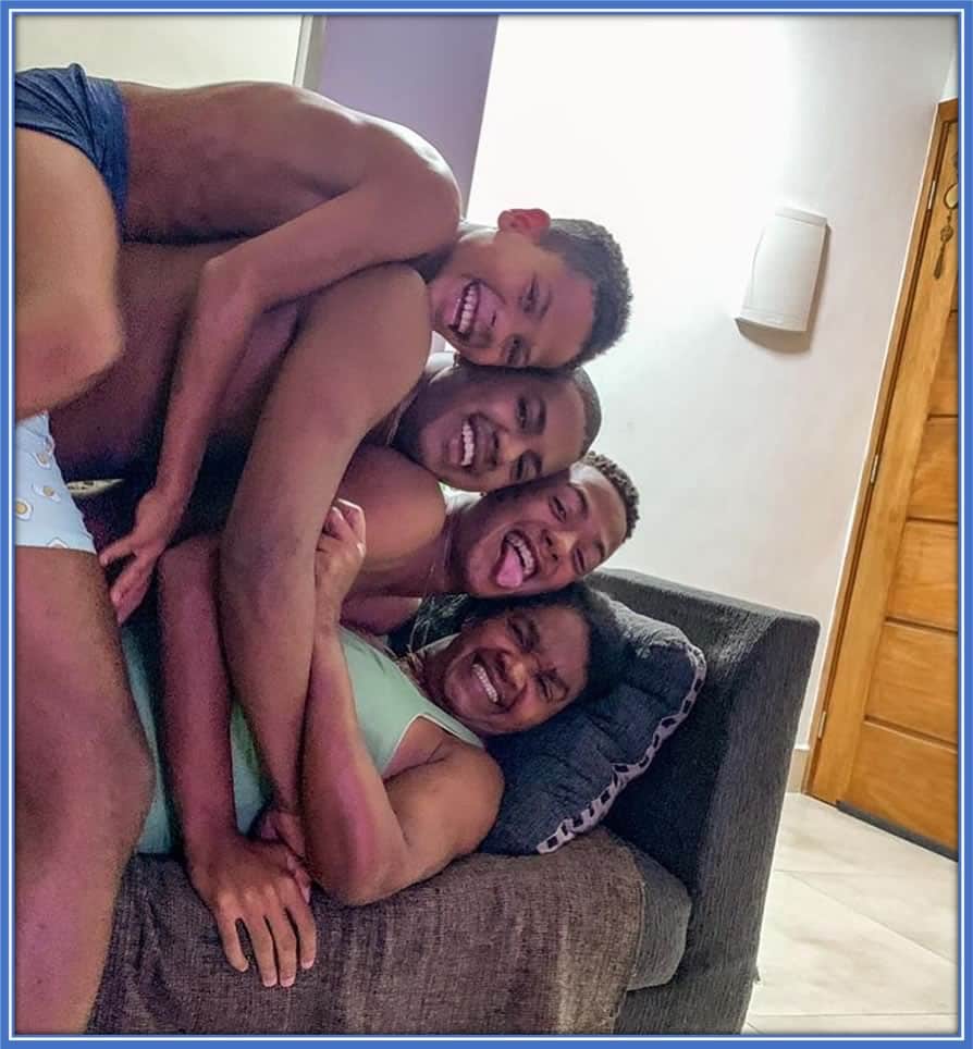 Irailda Dias is enveloped in joy as Angelo Gabriel and his brothers, Carlos and Julio, playfully crowd around her. Credit: Instagram/angelogabriel.