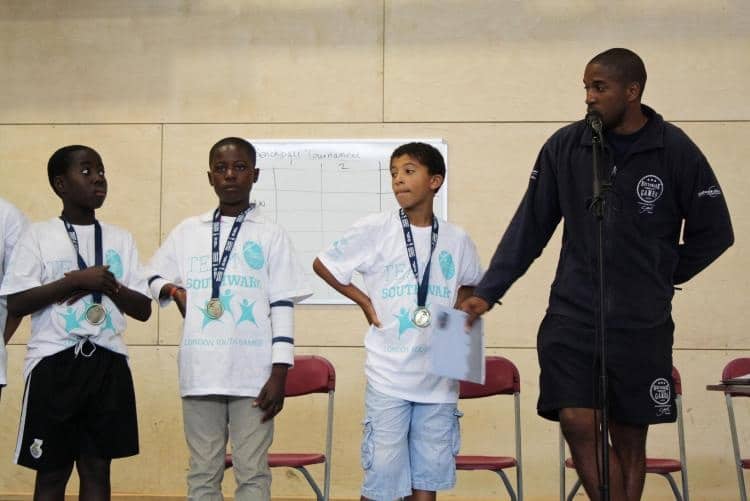 Victory under Guidance: Sancho, medal, stood on the far right next to Holmes-Lewis, the Southwark community coach who led them to triumph at the London youth football event. One of the great highlights of Jadon Sancho's Early Life.
