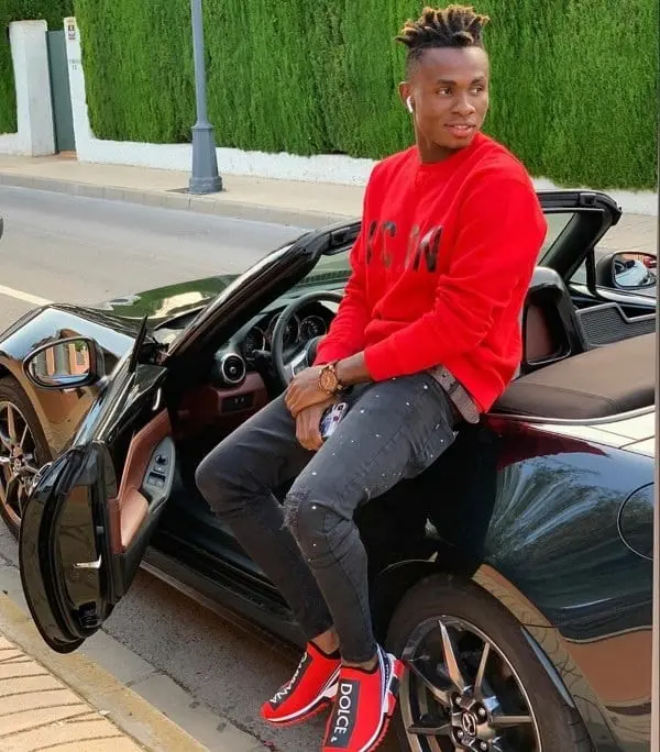 Samuel Chukwueze posing for a shot on his Mazda MX-5 Miata Convertible car.