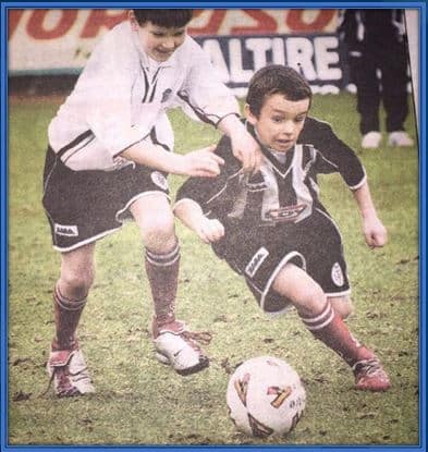 Young John McGinn pictured powering his way through bigger kids.