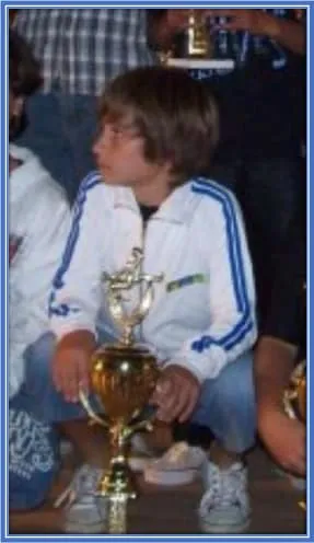 Alexis started his football journey on solid footing. This is him holding his first trophy.