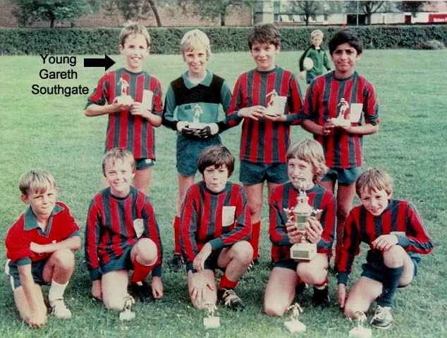 Balancing Brilliance: Pictured (back, from the left) with his U12 team, proudly hoisting their latest trophy.