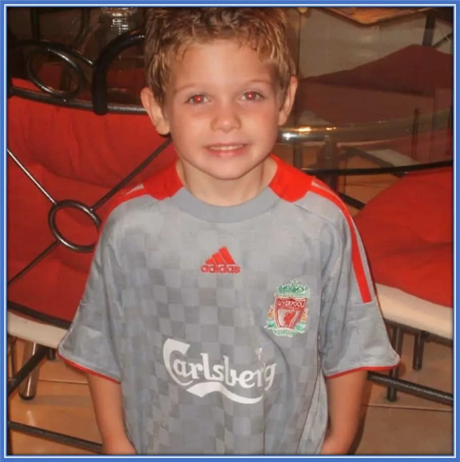 This is Cute Harvey taking a photo with his Liverpool shirt. He truly loved the club since childhood.