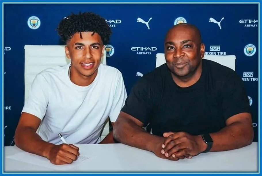 A Proud Moment, Rico signs his first professional contract as his dad (Rick) looks on joyfully.