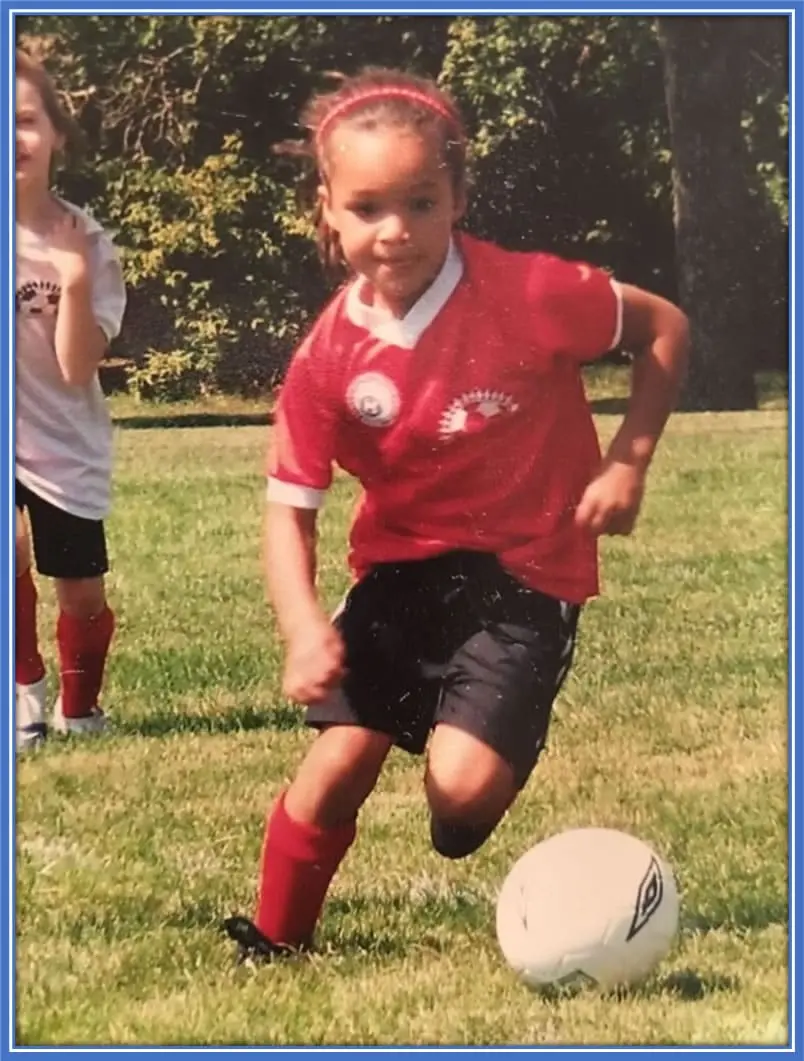 This image showcases a younger version of Sophia Smith, where her love for football is clearly evident from her appearance. Image Credit: justwomenssports.