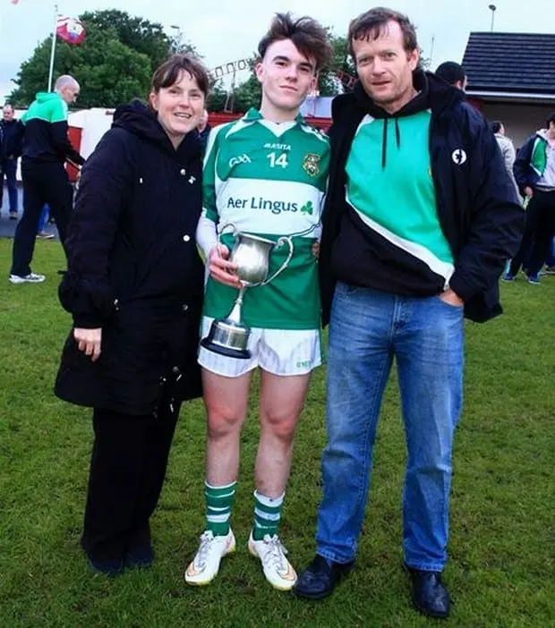 Aaron Connolly with his supportive parents after winning a trophy.