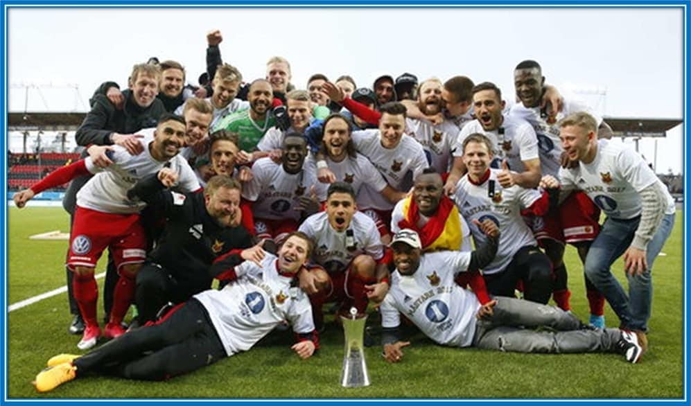 The young English manager celebrates with Östersund players as he helped them win a trophy.