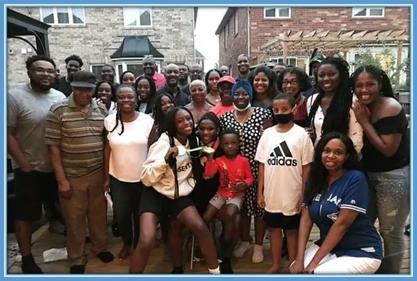 Deanne Rose and her extended family members celebrating after her win in the Olympic games.