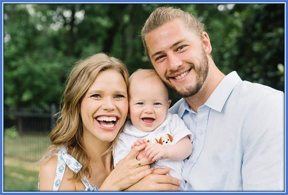 Tucker James Zimmerman takes a photo with his parents, Walker and Sally.