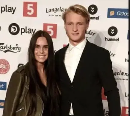 Cecilie Hornbaek and her lover, Kasper, take a photo at an event.