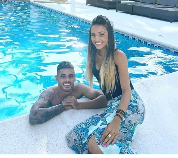 Isadora Nascimento and Emerson pose for a photograph at the poolside.