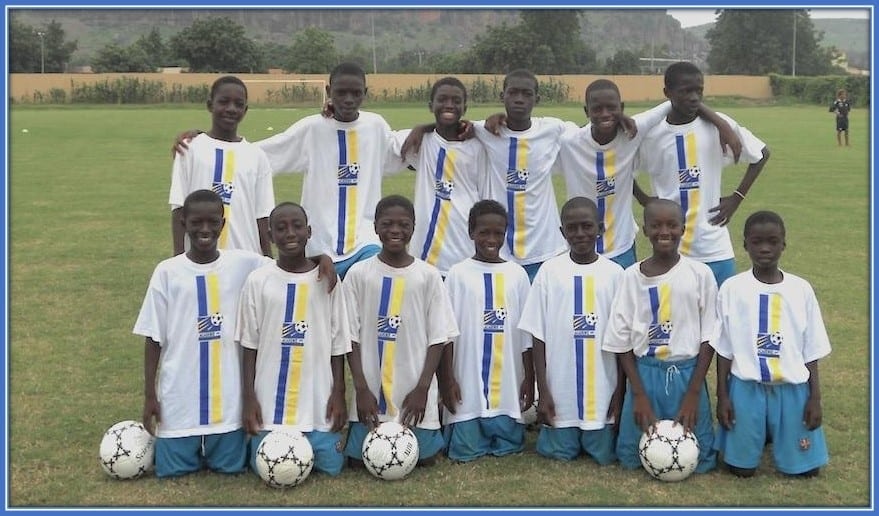 Can you spot him among the boys? He is third from right among the standing row!