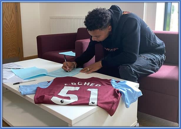 Capturing the Moment: A Thrilled Cameron Signs His Dream Contract with Aston Villa. Credit: Twitter@avfcofficial.