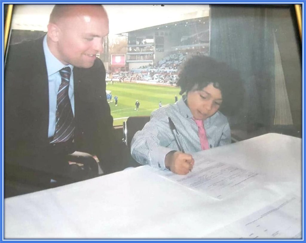 Archer's dad beams proudly as his son, a budding football gem, signs with one of the top clubs in the English Midlands at just eight years old.