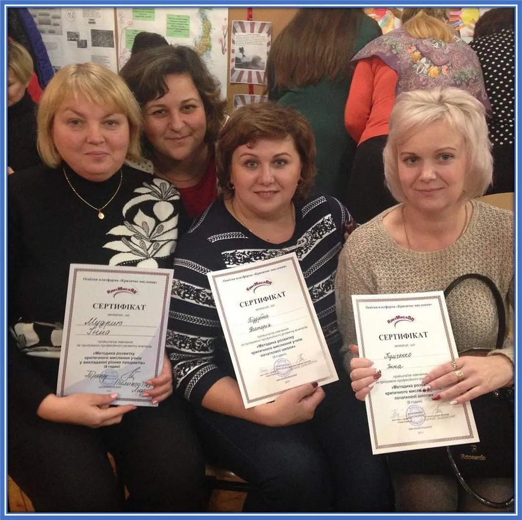 Mykhailo Mudryk's mum (far left) presents her certificate of achievement to fellow teachers at the school she teaches in Kharkiv Oblast.