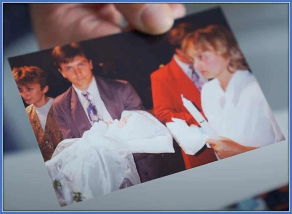 Beata, his Mum, is pictured holding a white candle, and Bogusław had little Piotr Zieliński, who was about to be baptised.