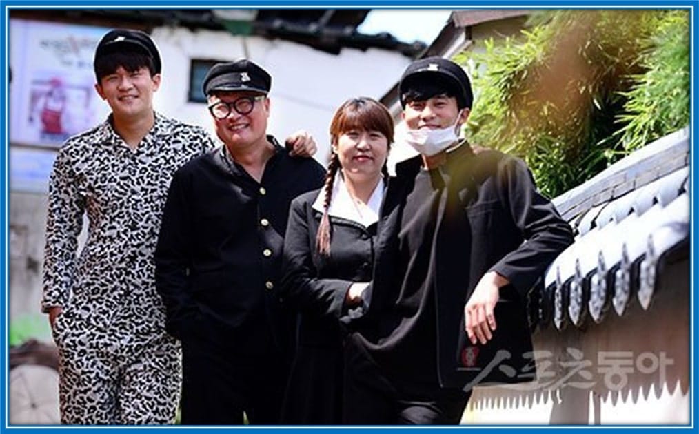 The South Korean Defender poses for a photo with his Dad, Mum and older brother.