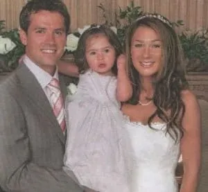 Louise and Michael, together with their daughter, on their wedding day.