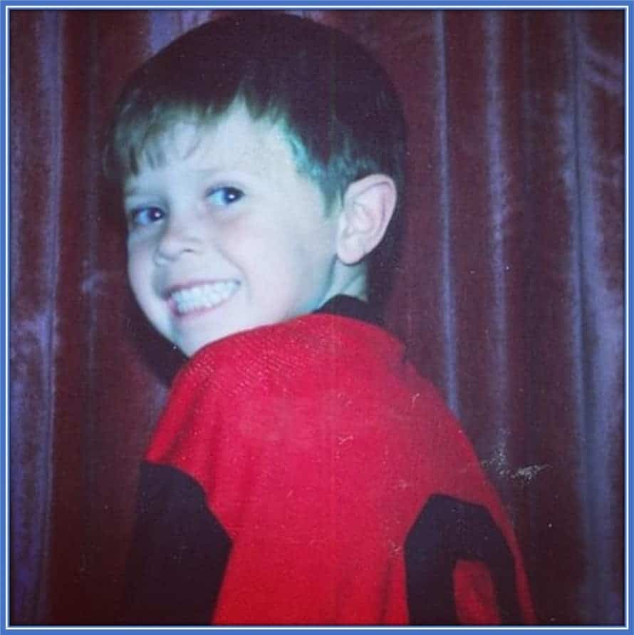 An excited Craig Goodwin wearing his first football jersey.