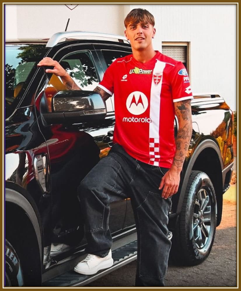 Daniel Maldini strikes a confident pose in front of his sleek four-wheel drive Highlander, blending style and practicality on and off the field.