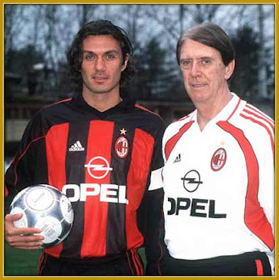 Cesare Maldini stands proudly alongside his son Paolo, both in AC Milan colors. In 2001, as head coach, Cesare guided the team with Paolo as captain—a rare and unforgettable moment in the Maldini legacy.