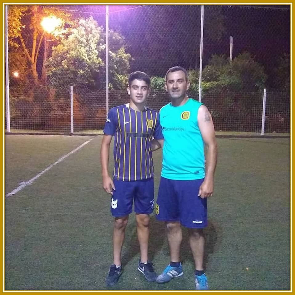 Father and son, standing strong under the night sky, their football boots still on after a hard-fought training session. A bond built on dedication, love, and shared dreams.