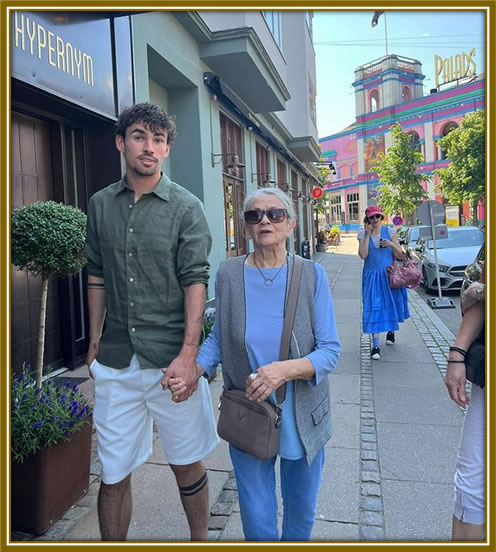 The Former Celtic player is strolling with his grandmother, Lis.