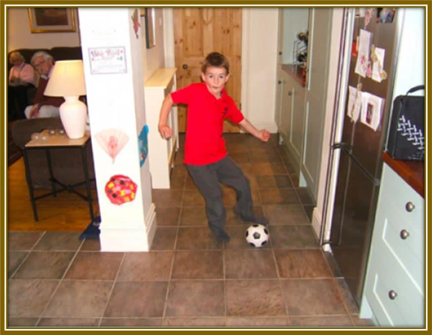 The young lad during his childhood playing in the sitting room