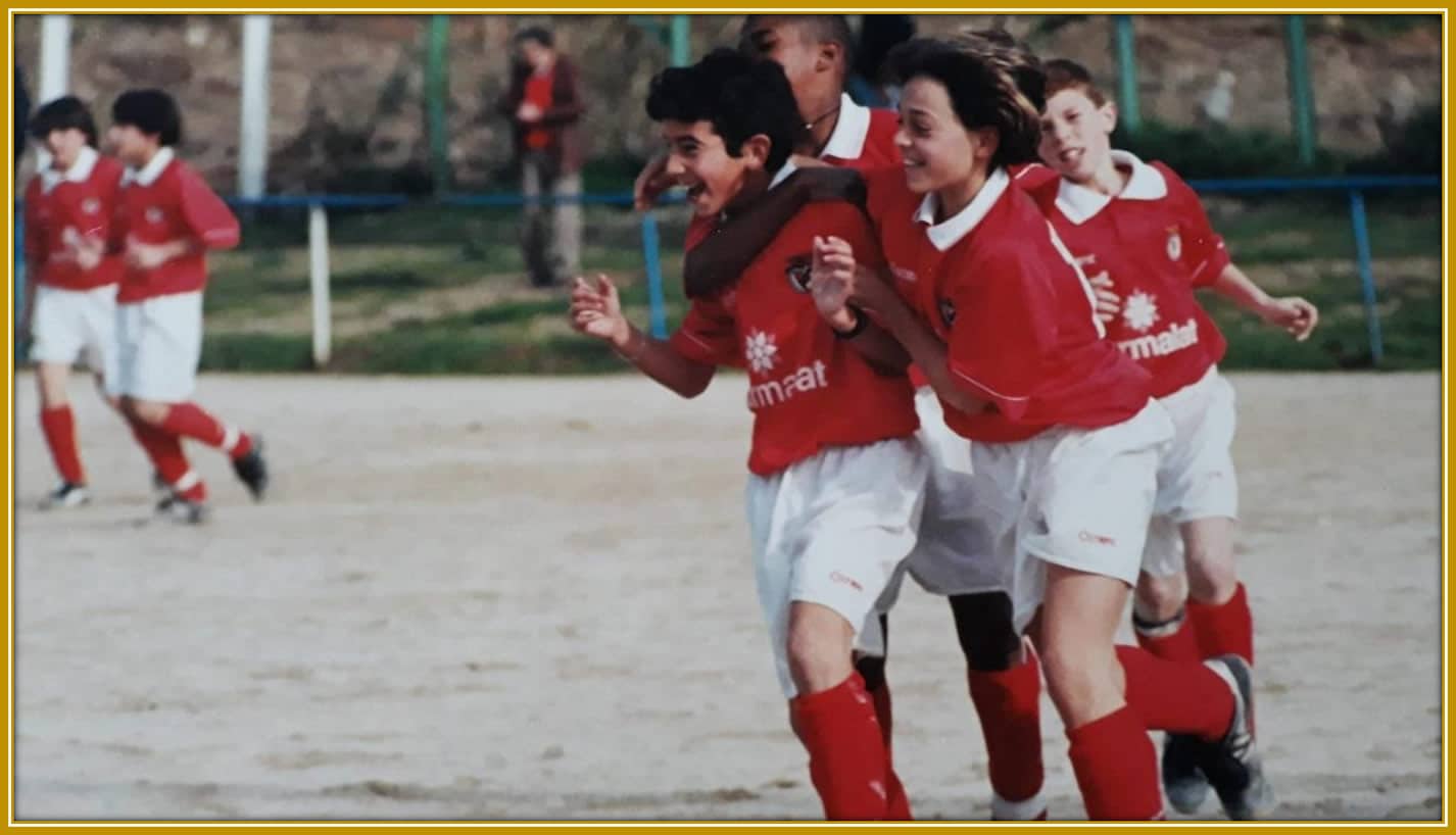 He celebrates with pure joy after scoring, capturing a moment that reflects his passion and hard work on the pitch.