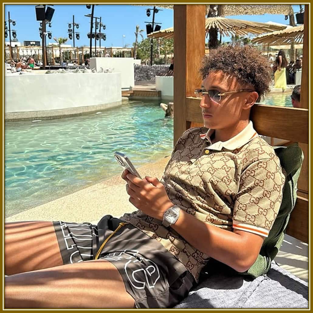 Unwinding by the pool: Eliesse Ben Seghir enjoys a quiet moment, staying connected while soaking in the calm vibes.