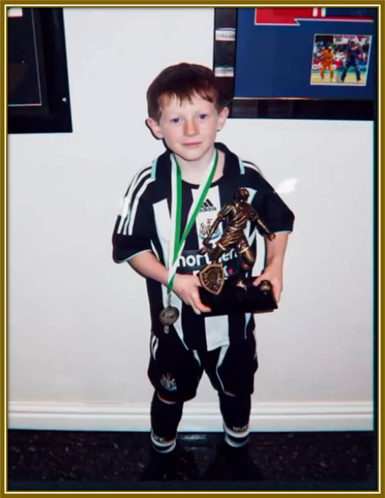 Here, he was a future Magpie in the making! Two-year-old Elliot Anderson rocking the full Newcastle United kit, complete with a medal and trophy. The passion started early!