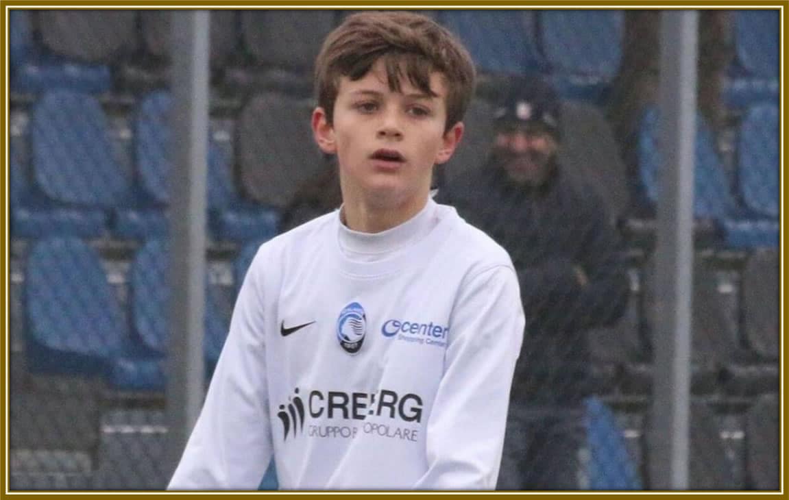 Bright-eyed and full of promise: A young Giorgio Scalvini shining in his Atalanta BC jersey, ready to take on the football world!