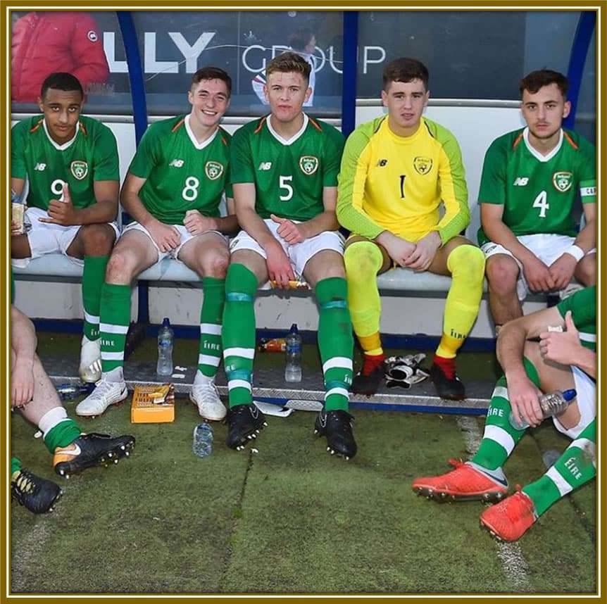 Young leader in the making: Nathan Collins, donning the Republic of Ireland U17 kit, exudes promise and confidence as he sits in the dressing room alongside his teammates.