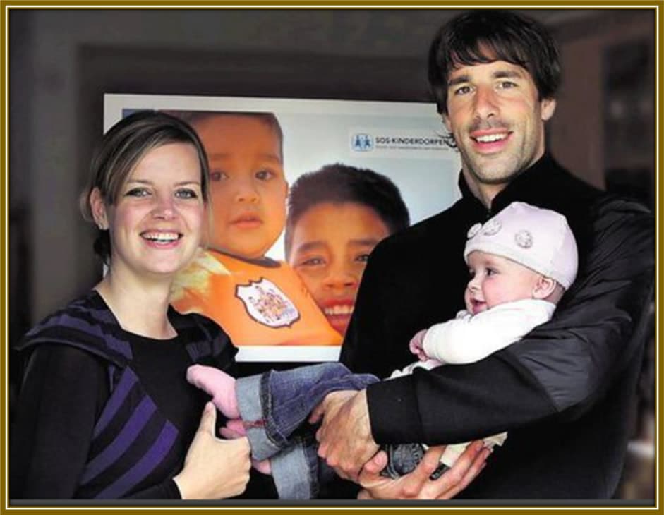 Ruud van Nistelrooy and his wife Leontien, proudly posing with their child, sharing a beautiful family moment.