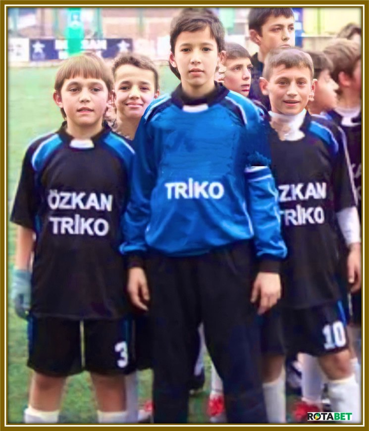 Altay stands tall among his teammates, dressed in goalkeeper gear. It's no surprise they handed him the role! His height and presence make him a natural in goal, ready to defend with all his might!