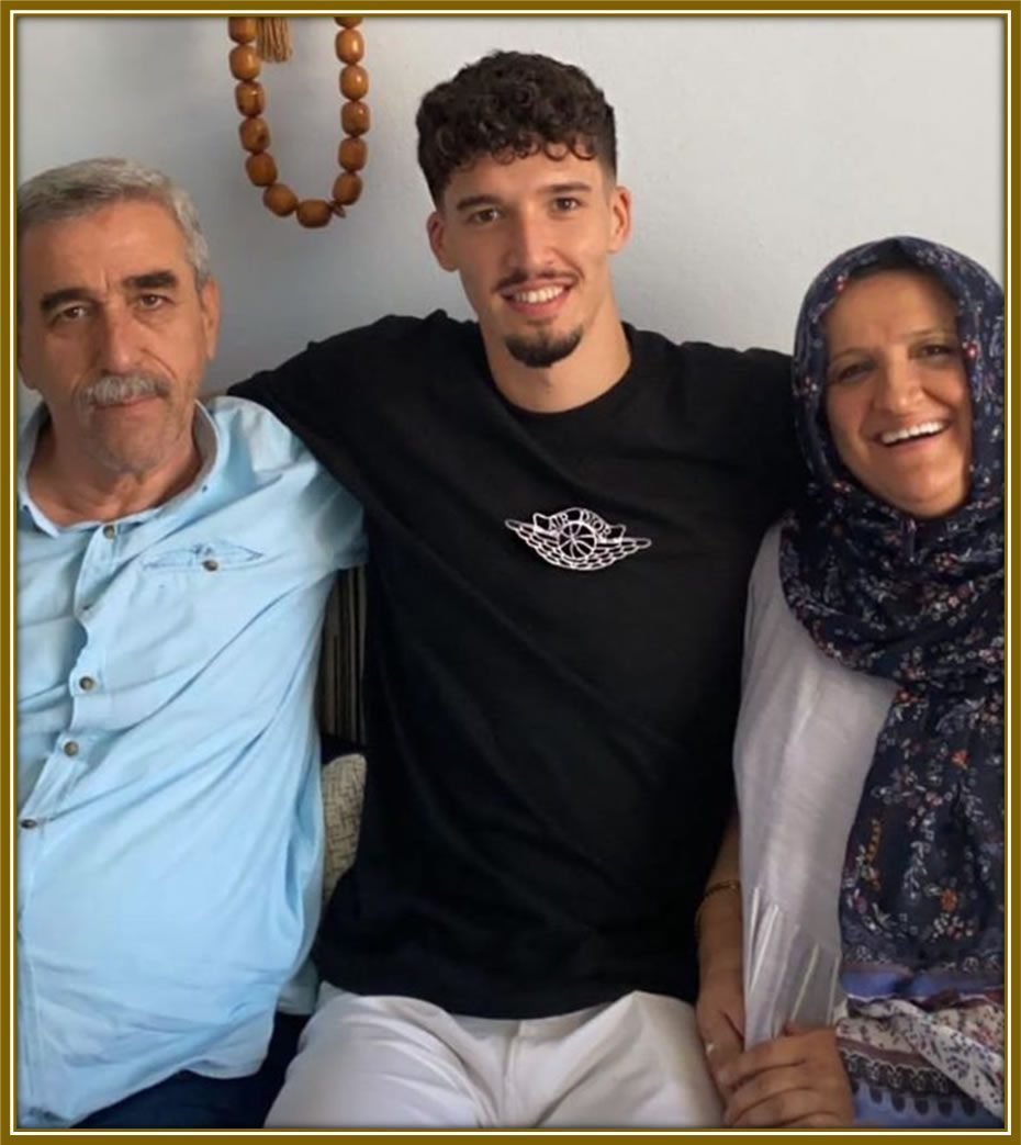 Meet the proud parents of Altay Bayındır! His cheerful dad, with a touch of wisdom in his smile, and his youthful, radiant mum, share a joyful moment with their son at the center of their world. 