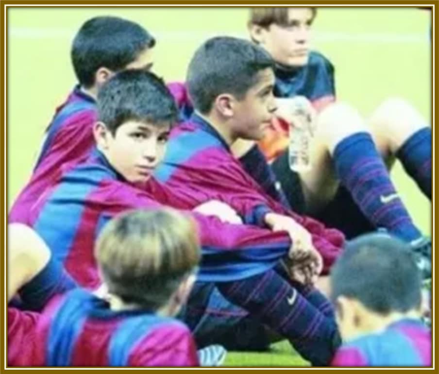 A young Cesc Fàbregas at Barcelona's academy, reflecting on the challenges ahead, yet determined to make his mark.