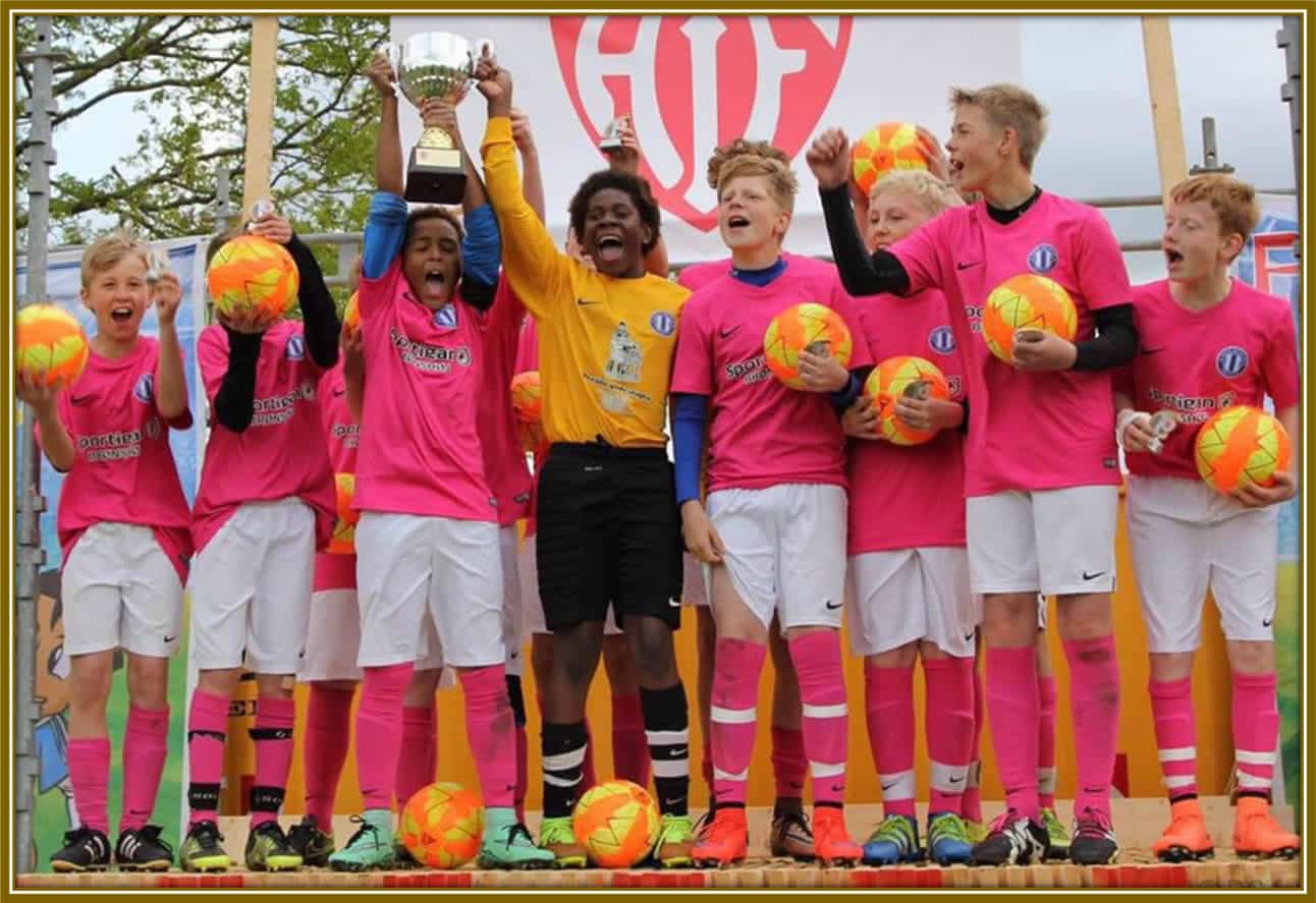 A young Gabriel Dorgu celebrating a hard-earned trophy with his teammates. 