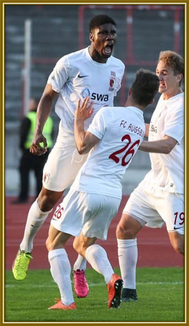 Danso fired up with passion, celebrating a goal with unstoppable energy and fierce determination.